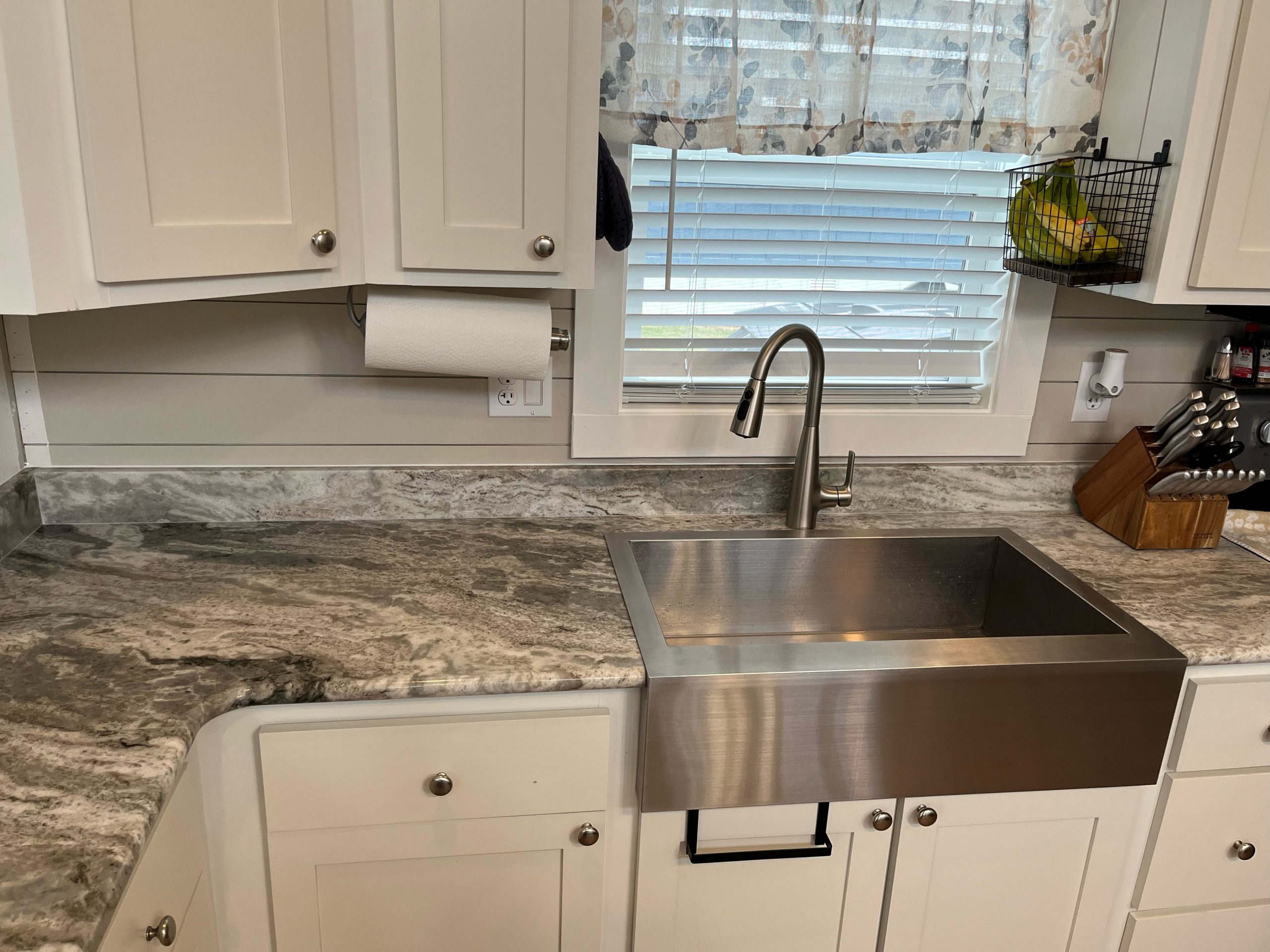 Kitchen Sink Remodel: Finding the Perfect Fit Willis, TX kitchen with stainless steel sink, white cabinets, and stone countertops