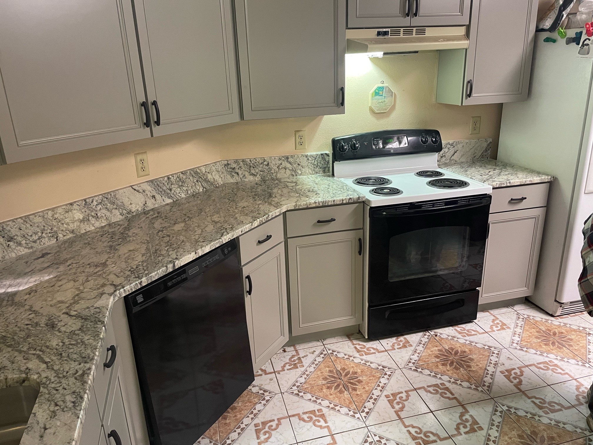 Granite Countertops: Pros and Cons to Consider Willis, TX a modern kitchen with cool toned granite countertops and gray cabinets