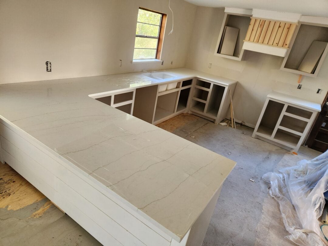 Quartz Kitchen Worktops That Bring Lasting Style at Home Large modern kitchen with white quartz countertops