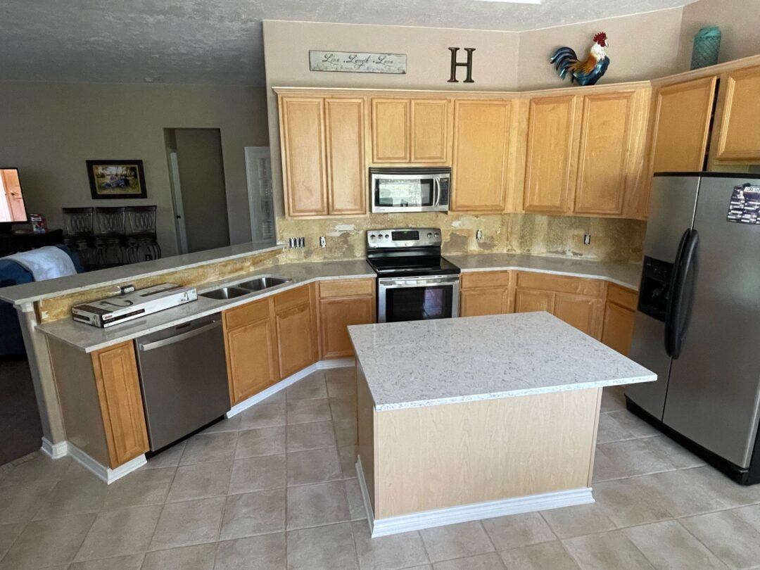 | R&D Marble, Inc. neutral colored kitchen with quartz countertop island