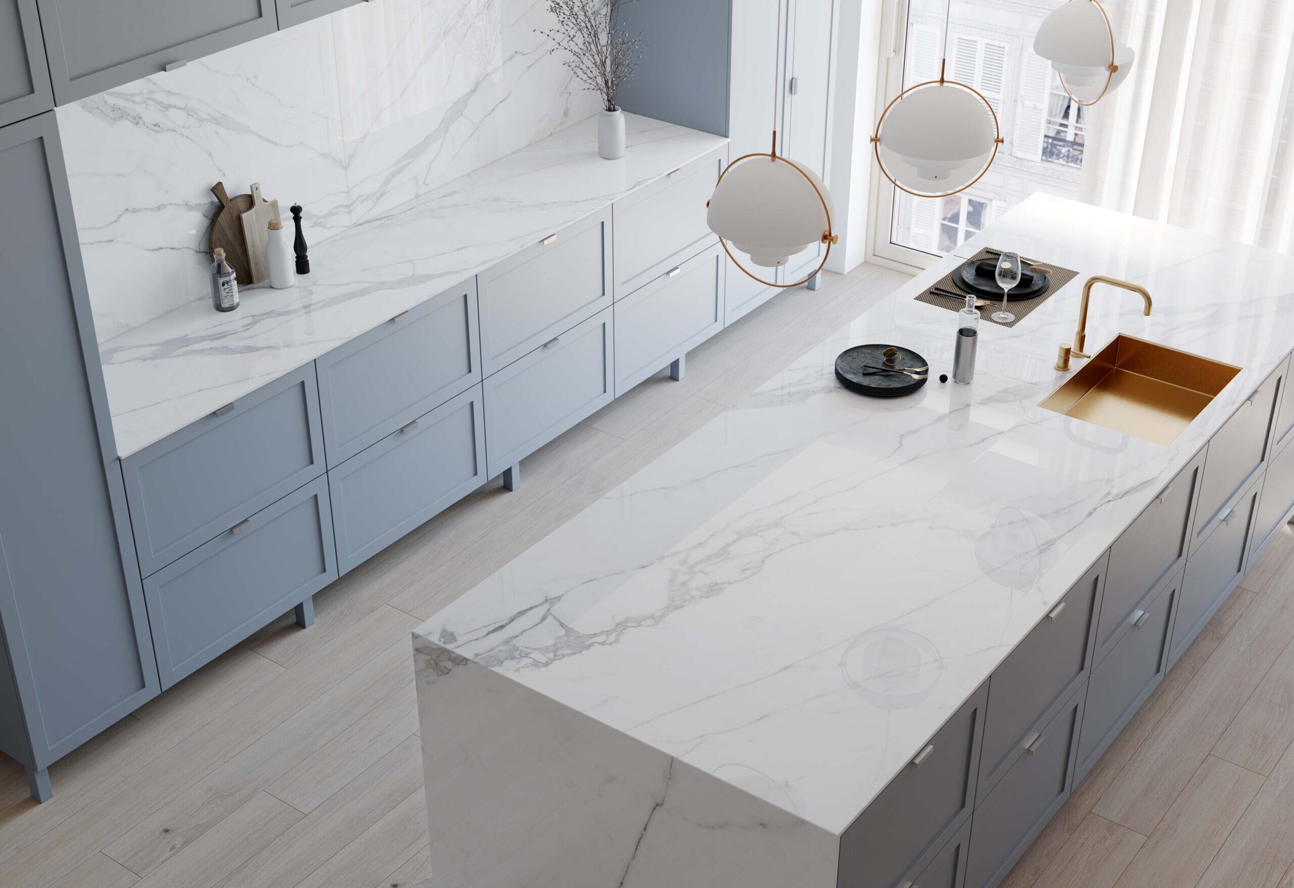 High angle view of a light grey toned kitchen with white Teracanto porcelain countertops in the shade statuario bianco.