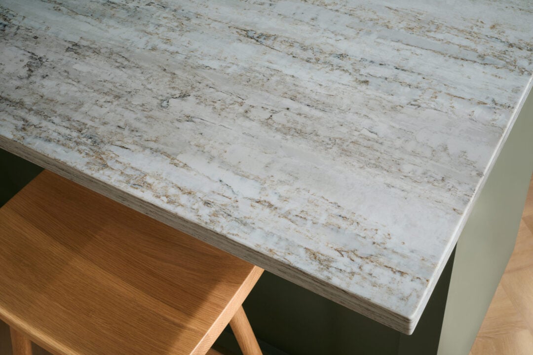 What Is An Eased Edge Countertop? | R&D Marble, Inc. Close up of a quartz eased edge countertop island in a green kitchen.