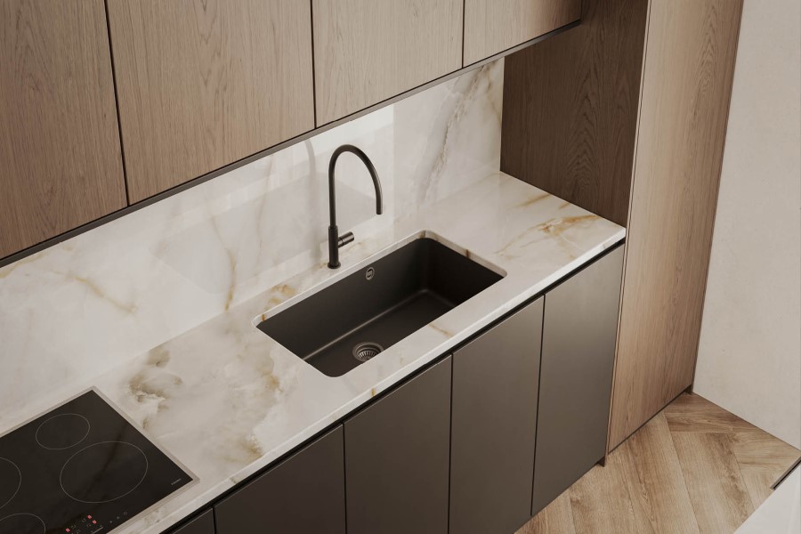 | R&D Marble, Inc. A warm neutral toned backsplash and countertop installed in a modern kitchen with brown cabinets.