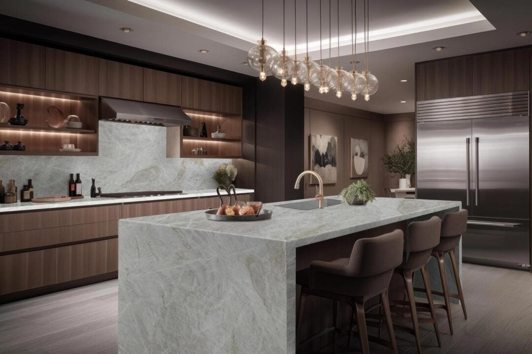 | R&D Marble, Inc. A luxury kitchen with warm toned cabinetry and marble countertops, backsplash, and waterfall island.