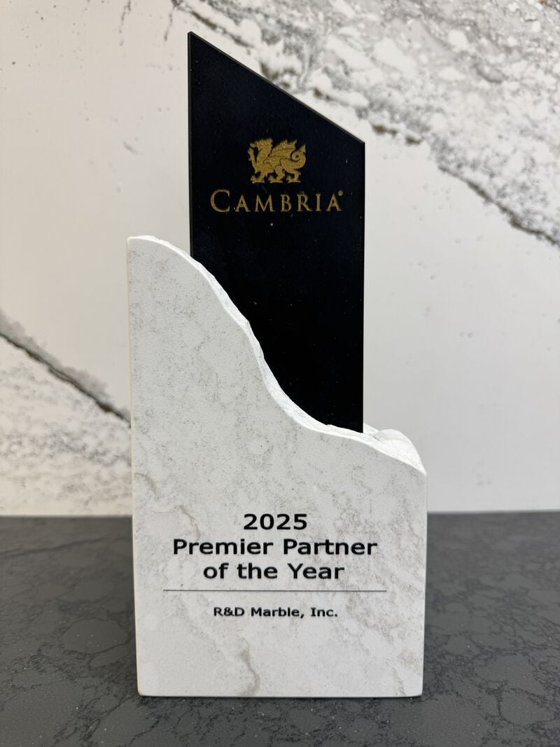 Marble award with a black Cambria plaque reading '2025 Premier Partner of the Year' for R&D Marble, Inc.
