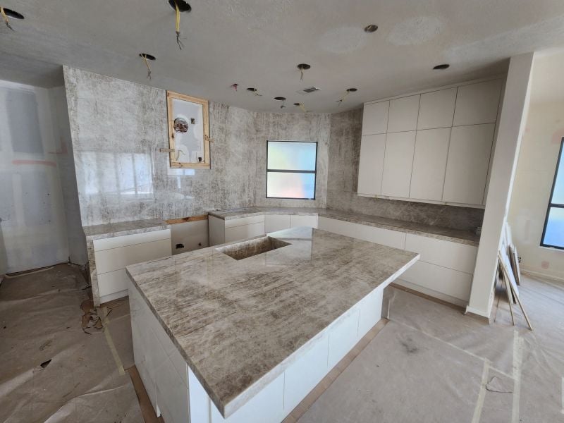 Quartzite Installation: What to Expect From Professionals A kitchen being renovated with quartzite countertops being installed.