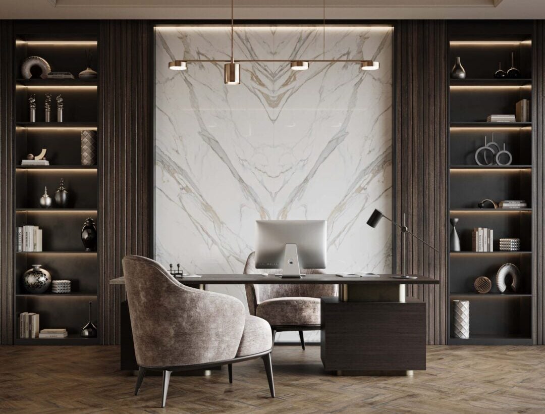Modern office with marble backsplash, dark wood shelving, and a desk with computer and plush chairs.