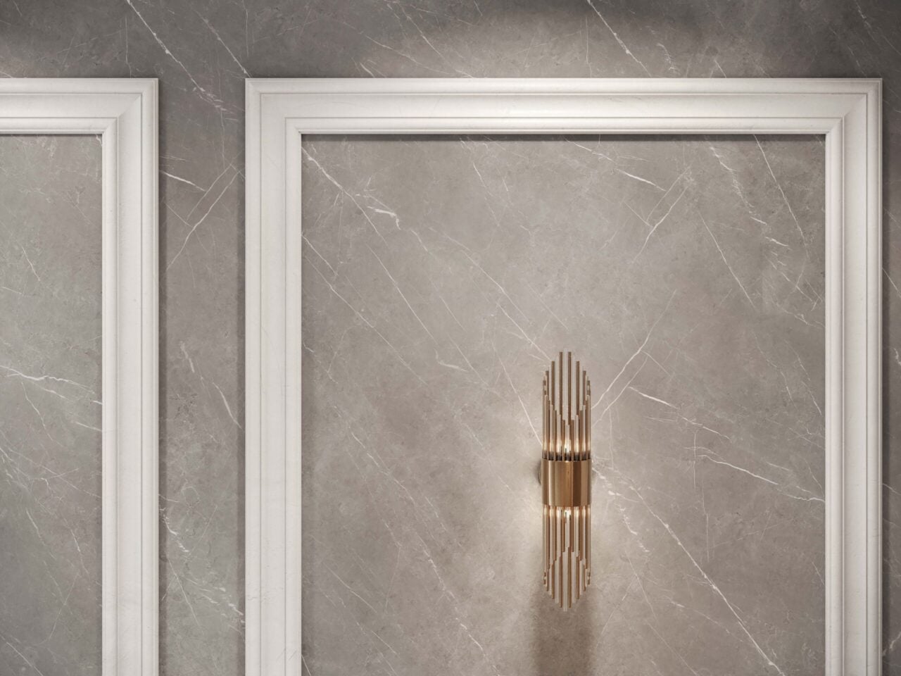 Interior wall with white picture-frame molding and a gold multi-tier chandelier against a gray marble backdrop.